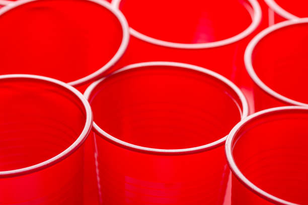 istock Rows of red drinking cups. Conceptual poster. Zero waste plastic free ocean nature pollution environmental conservation concept. Design template with copy space 1159567431