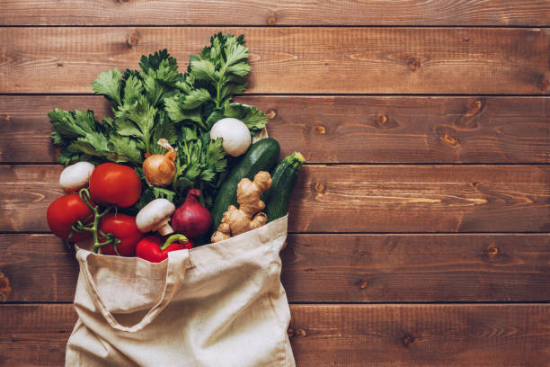 Fresh vegetables in the eco cotton bag at the kitchen counter