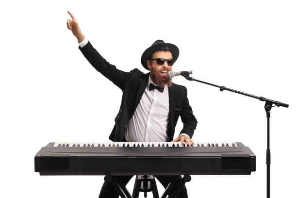 Male artist playing a keyboard and pointing with hand