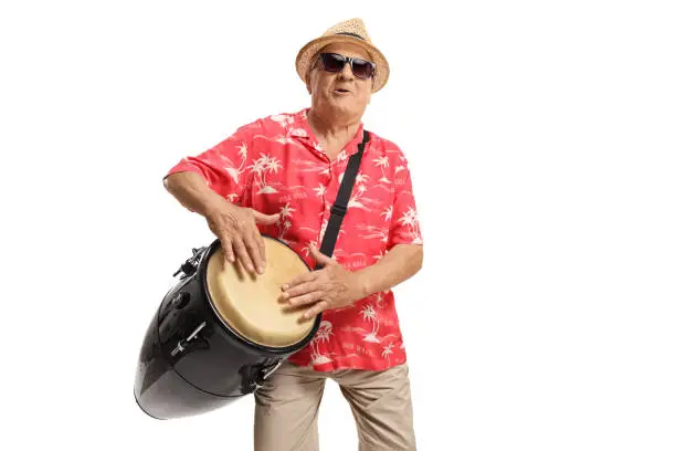 Mature man playing a conga drum and singing isolated on white background