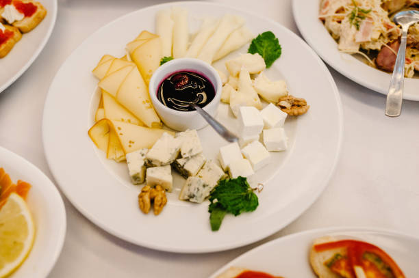 istock The holiday table with appetizer cheese, meat snacks. Served table with food. Festive table. Wedding table, food. 1159568590