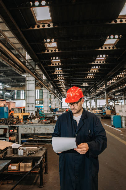 istock Manual worker at metal industry, looking at clipboard. 1159568696