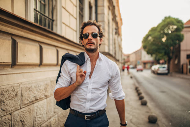 istock Handsome gentleman walking on the sidewalk 1159570226