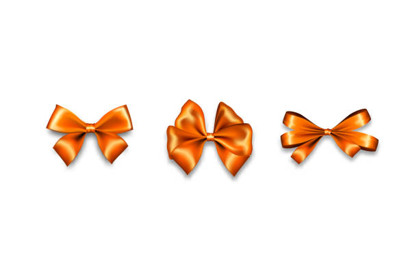 istock Holiday satin gift bow knot ribbon orange gold 1159570248