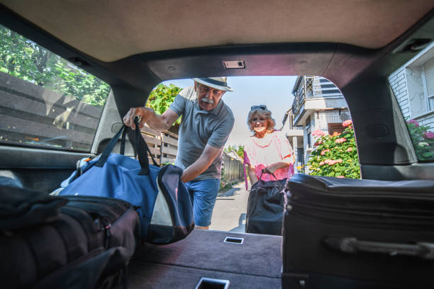 istock Senior Couple Loading Car for Vacation Road Trip 1159570560