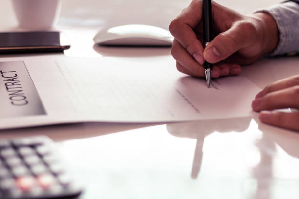 istock Businessman signing a document in office 1159570660