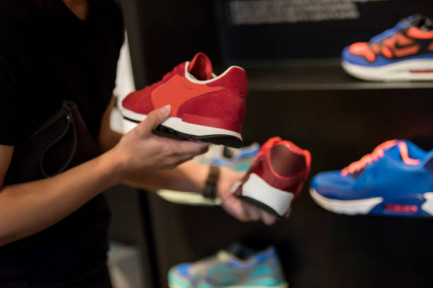 istock Unrecognizable man choosing cneakers in the store 1159571617