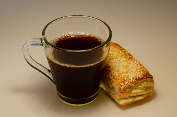 Breakfast with coffee, sweets and toast. Cozy calm meal in the morning in the sunshine.