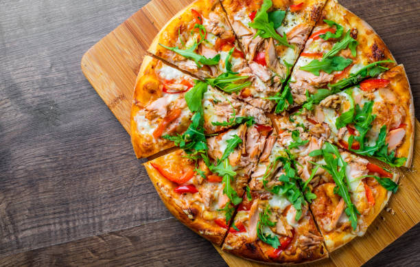 pizza with mozzarella cheese, salmon fish, tomato sauce, pepper. italian pizza on wooden table background - pizza tuna prepared fish cheese imagens e fotografias de stock