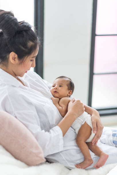istock Newborn baby sleeping in bed 1159575318