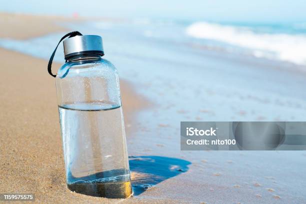 Reusable Water Bottle On The Beach Stock Photo - Download Image Now - Water Bottle, Bottle, Water