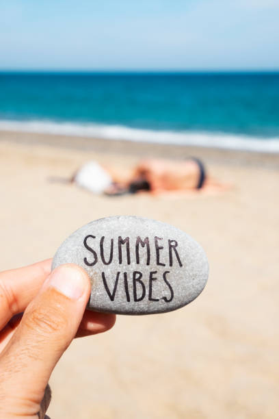 istock text summer vibes in a stone on the beach 1159575593
