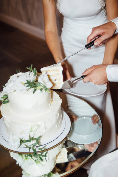 istock Happy bride and groom cut the cake. Evening ceremony 1159575791