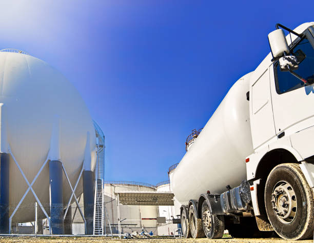Gas container truck and heavy petrochemical industries plant Gas container truck and heavy petrochemical industries plant liquefied petroleum gas photos stock pictures, royalty-free photos & images