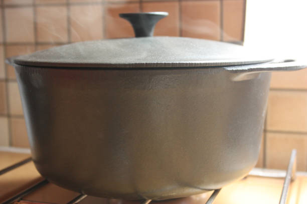 istock Cast iron pot being cooked on a gas cooktop 1159576388