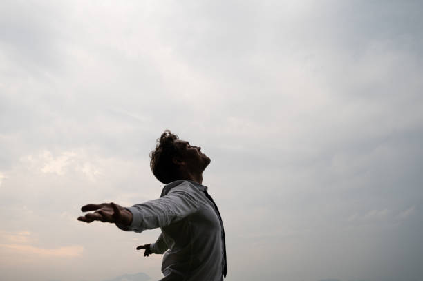 istock Peaceful young businessman standing with his arms spread 1159576808