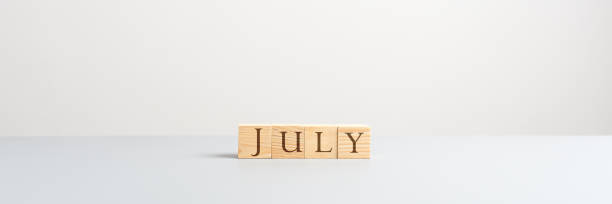 istock July spelled with wooden cubes 1159577134