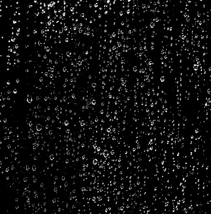 Water ( rain ) drops on glass on  a Black Background 