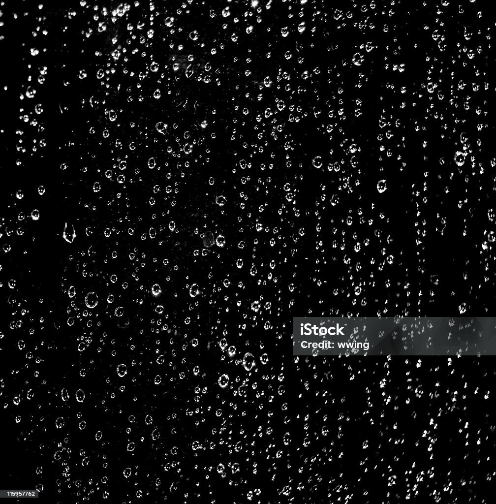 Black drops on a window  with copy space. Water ( rain ) drops on glass on  a Black Background  Drop Stock Photo