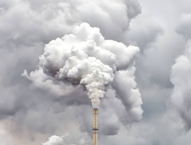 istock Smoke from factory pipe against dark overcast sky 1159581785