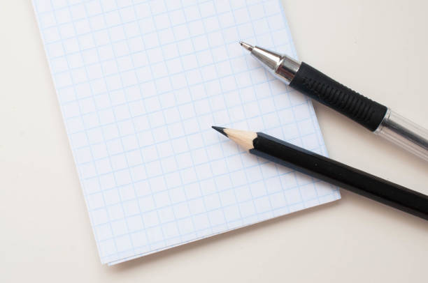 istock Notebook with a place for an inscription and a black pencil on a neutral background 1159582619