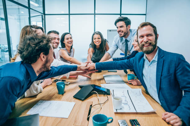 istock Business people stacking hands in conference room 1159582914