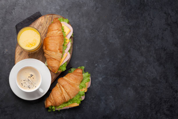 istock Coffee, orange juice and croissant sandwich 1159583038