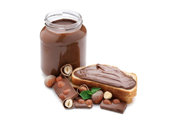 istock Melted chocolate with hazelnuts and bread isolated on white background 1159583205