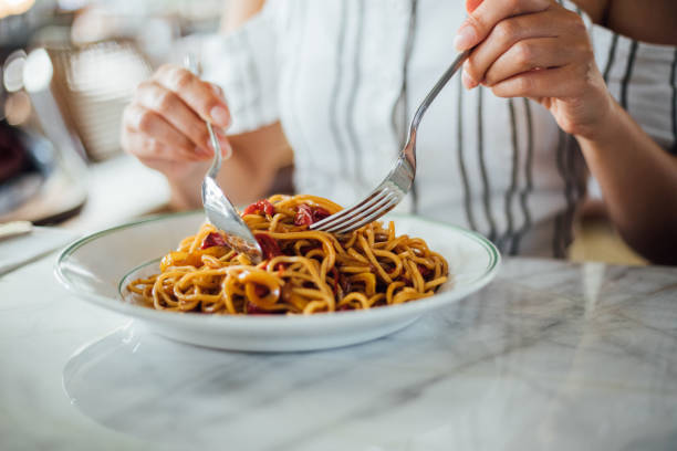 istock Woman eating delicious,Focus on hand 1159585382