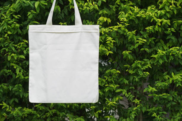 istock fabric bag hanging on green leaf background 1159585405