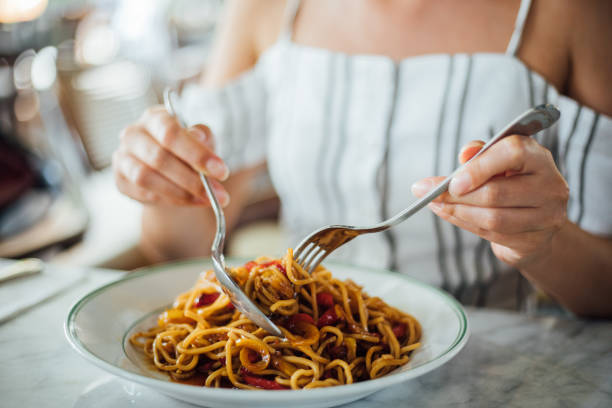 istock Woman eating delicious,Focus on hand 1159585416