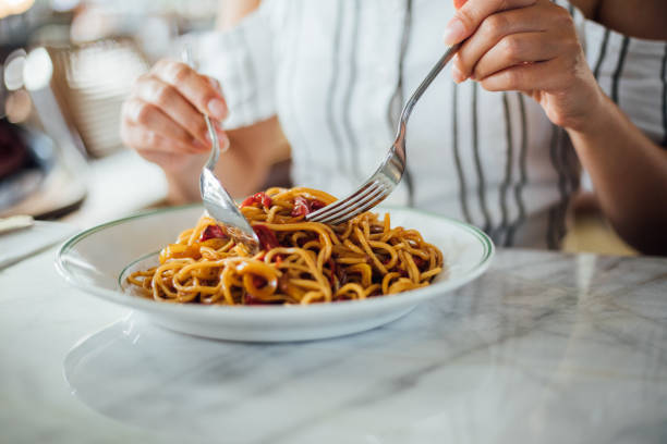 istock Woman eating delicious,Focus on hand 1159585423
