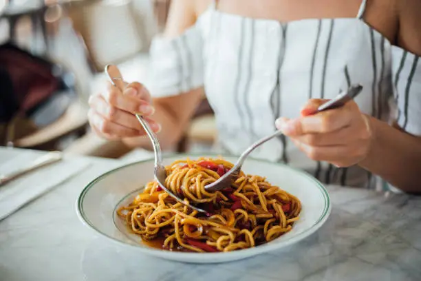 Photo of Woman eating delicious,Focus on hand