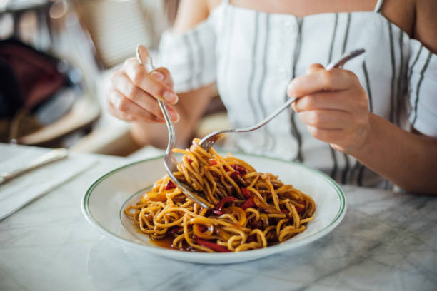 istock Woman eating delicious,Focus on hand 1159585478