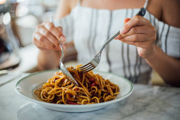istock Woman eating delicious,Focus on hand 1159585479
