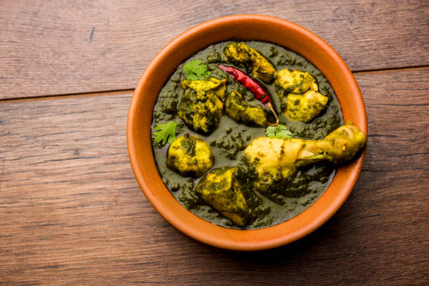 palak/spinach Chicken or Murg Saagwala served in a bowl with Naan and rice