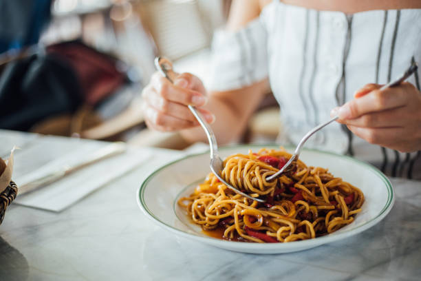 istock Woman eating delicious,Focus on hand 1159585534