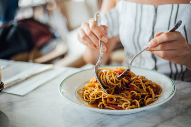 istock Woman eating delicious,Focus on hand 1159585572
