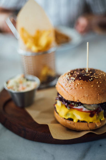 istock Woman eating beef burger 1159585620