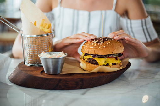 Woman eating beef burger