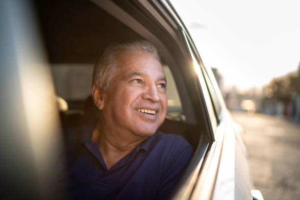 istock Smiling senior car passenger looking out of window 1159586742