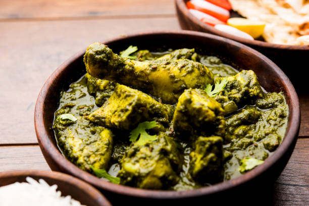 istock palak/spinach Chicken or Murg Saagwala served in a bowl with Naan and rice 1159586820