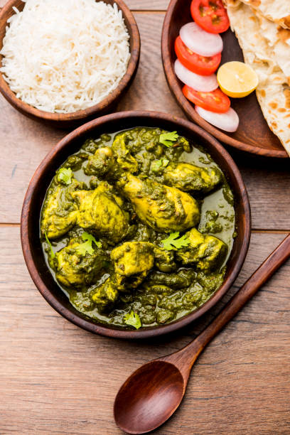 istock palak/spinach Chicken or Murg Saagwala served in a bowl with Naan and rice 1159586963