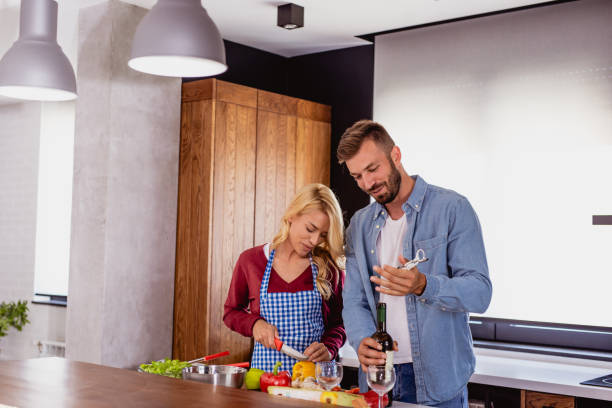 istock young couple preparing food in the kitchen 1159587468