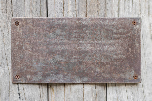 istock Rusted metal plates on the old wooden background 1159588547