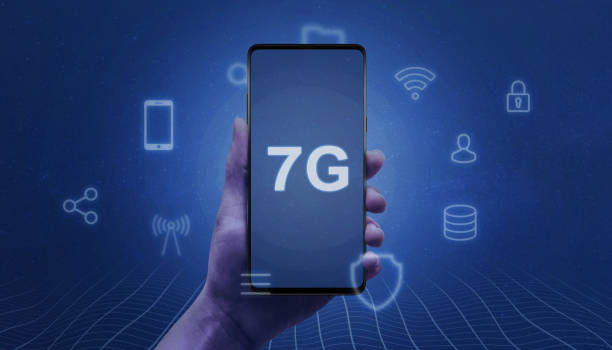 istock 7G network abstract concept. Smart phone in woman hand with 7G text on the screen surrounded by service icons. 1159588928