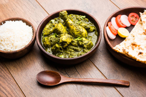 istock palak/spinach Chicken or Murg Saagwala served in a bowl with Naan and rice 1159589835