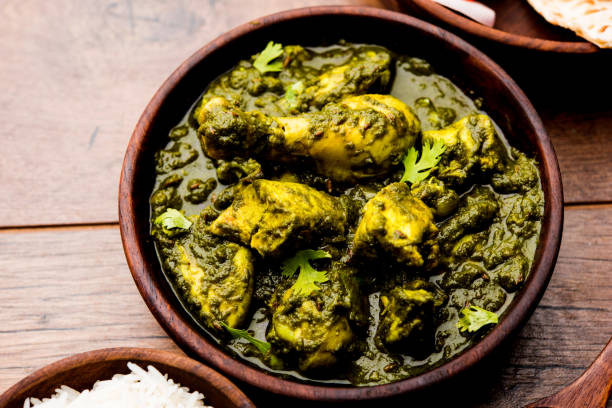 istock palak/spinach Chicken or Murg Saagwala served in a bowl with Naan and rice 1159589902