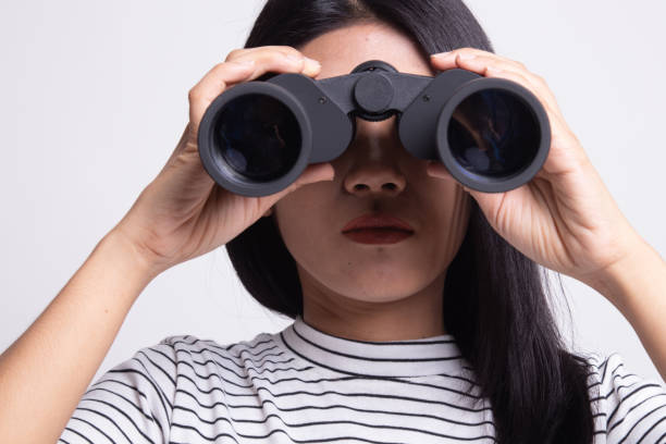 istock Young Asian woman with binoculars. 1159589962