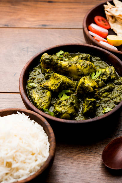 istock palak/spinach Chicken or Murg Saagwala served in a bowl with Naan and rice 1159589981